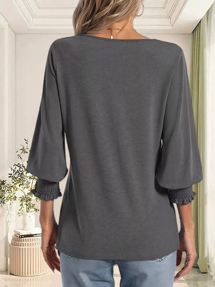 Notched V-neck three-quarter sleeve top with smocked cuffs