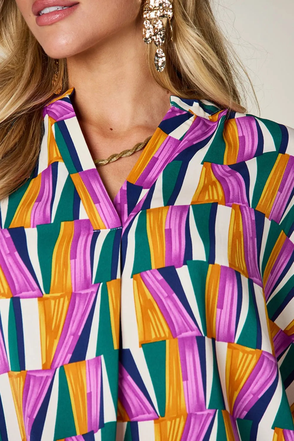 Geometric print notched neck dolman sleeve top