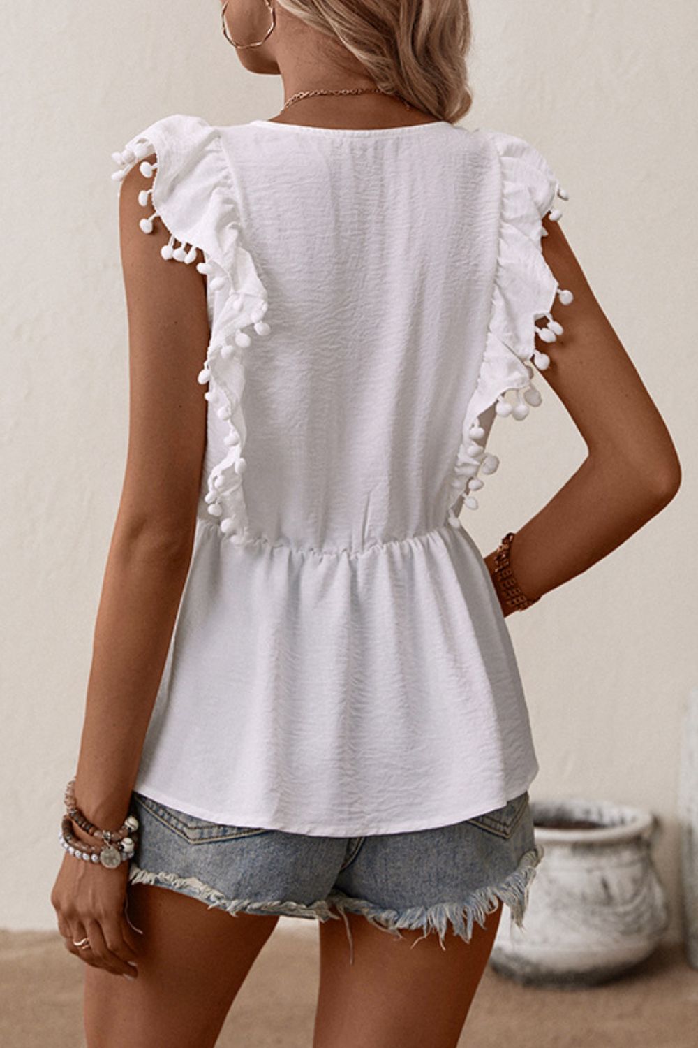 Embroidered floral babydoll top with pom-pom trim