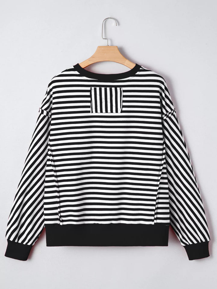 Exposed seam striped drop-shoulder pullover top
