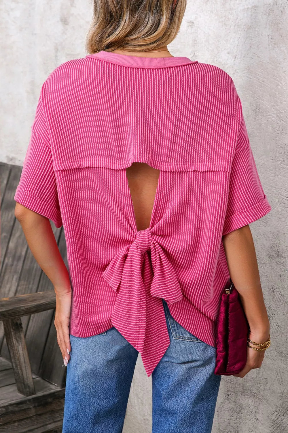 Deep Rose Ribbed knit short sleeve top with cutout bow-tie back