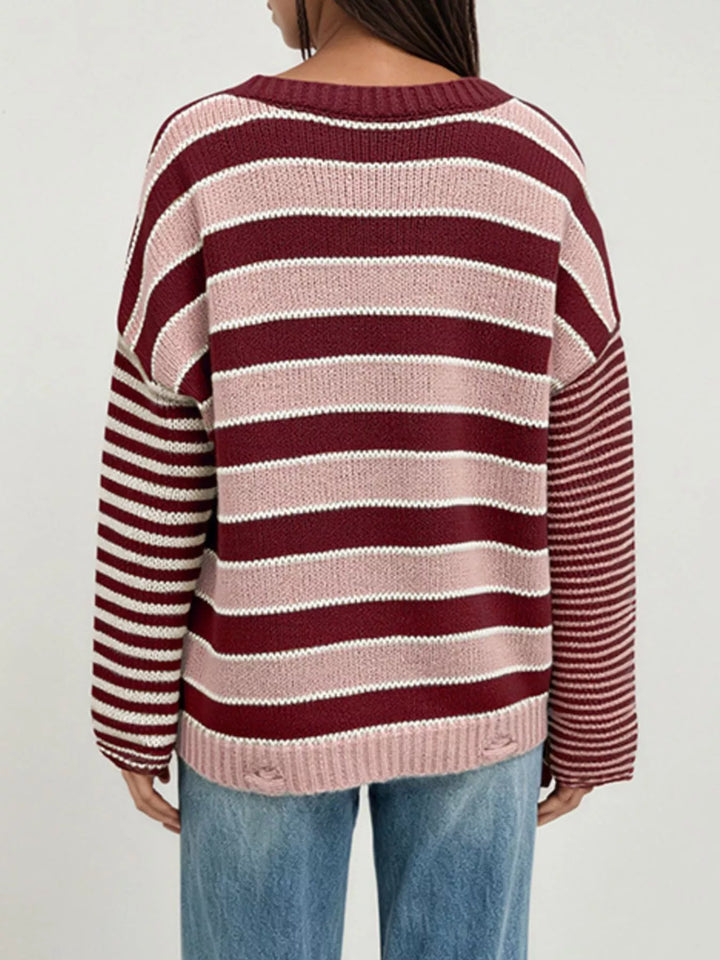 Distressed striped oversized knit sweater with raw hem