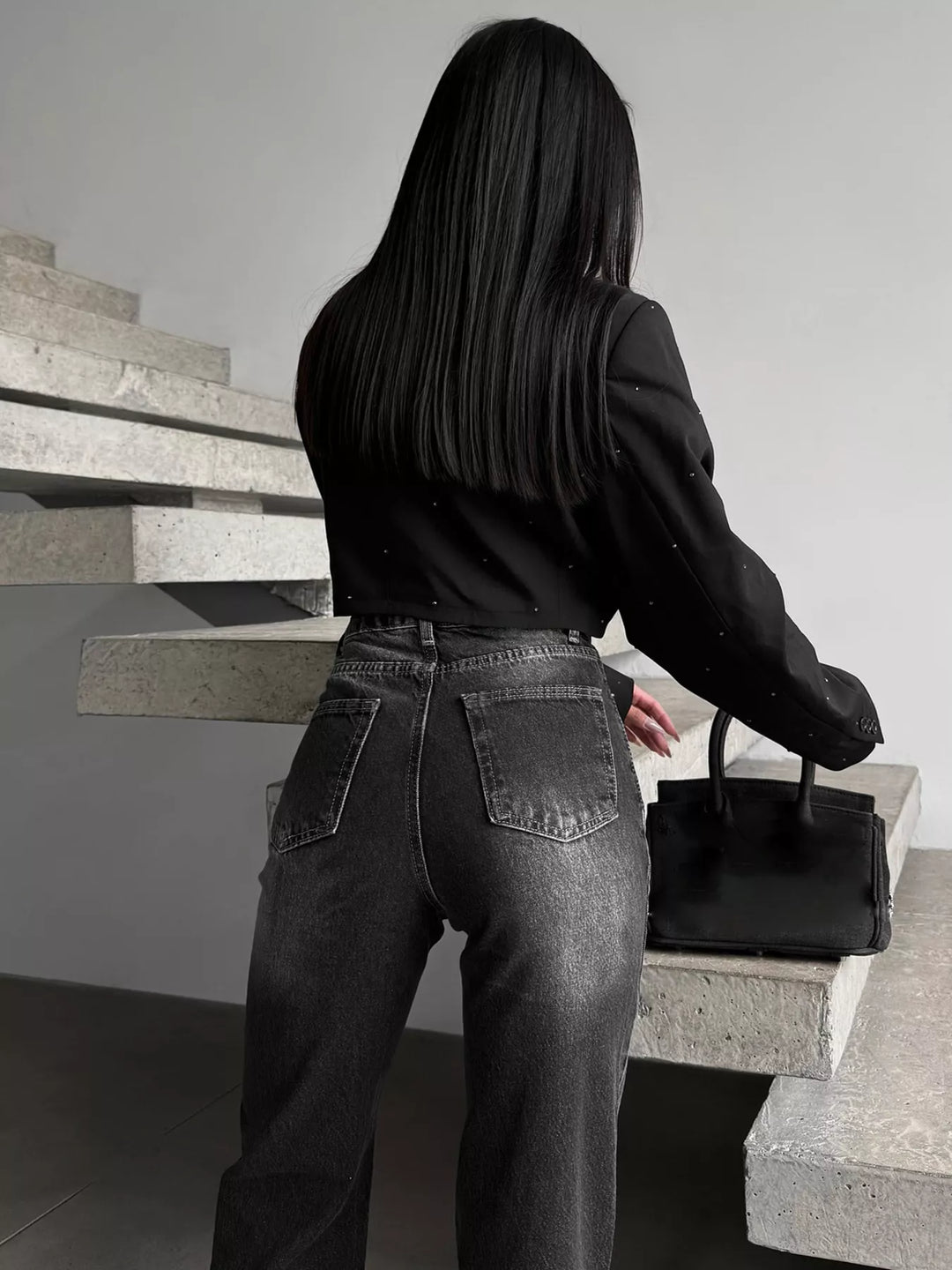 High-rise wide-leg jeans with crossover waistband and slit hem