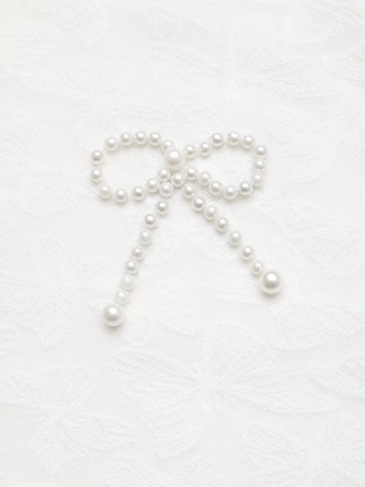 Butterfly-textured round neck top with pearl bow