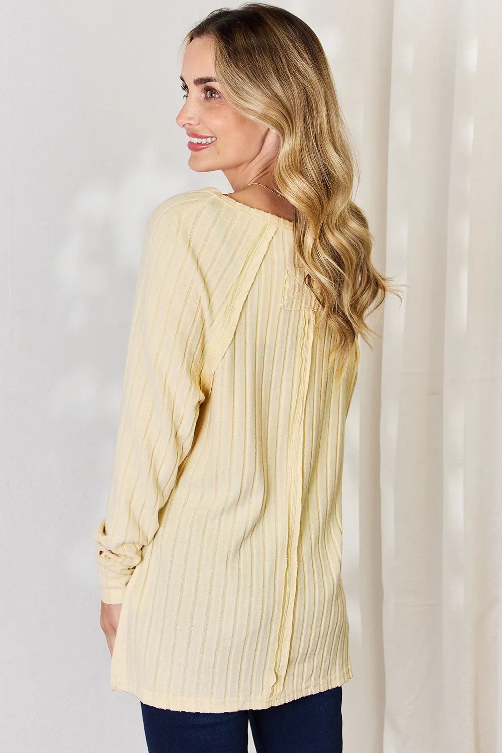Ribbed knit round neck long sleeve top with side slits