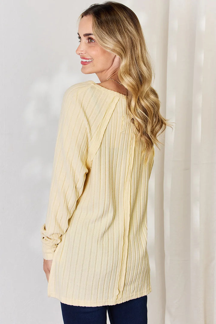 Ribbed knit round neck long sleeve top with side slits