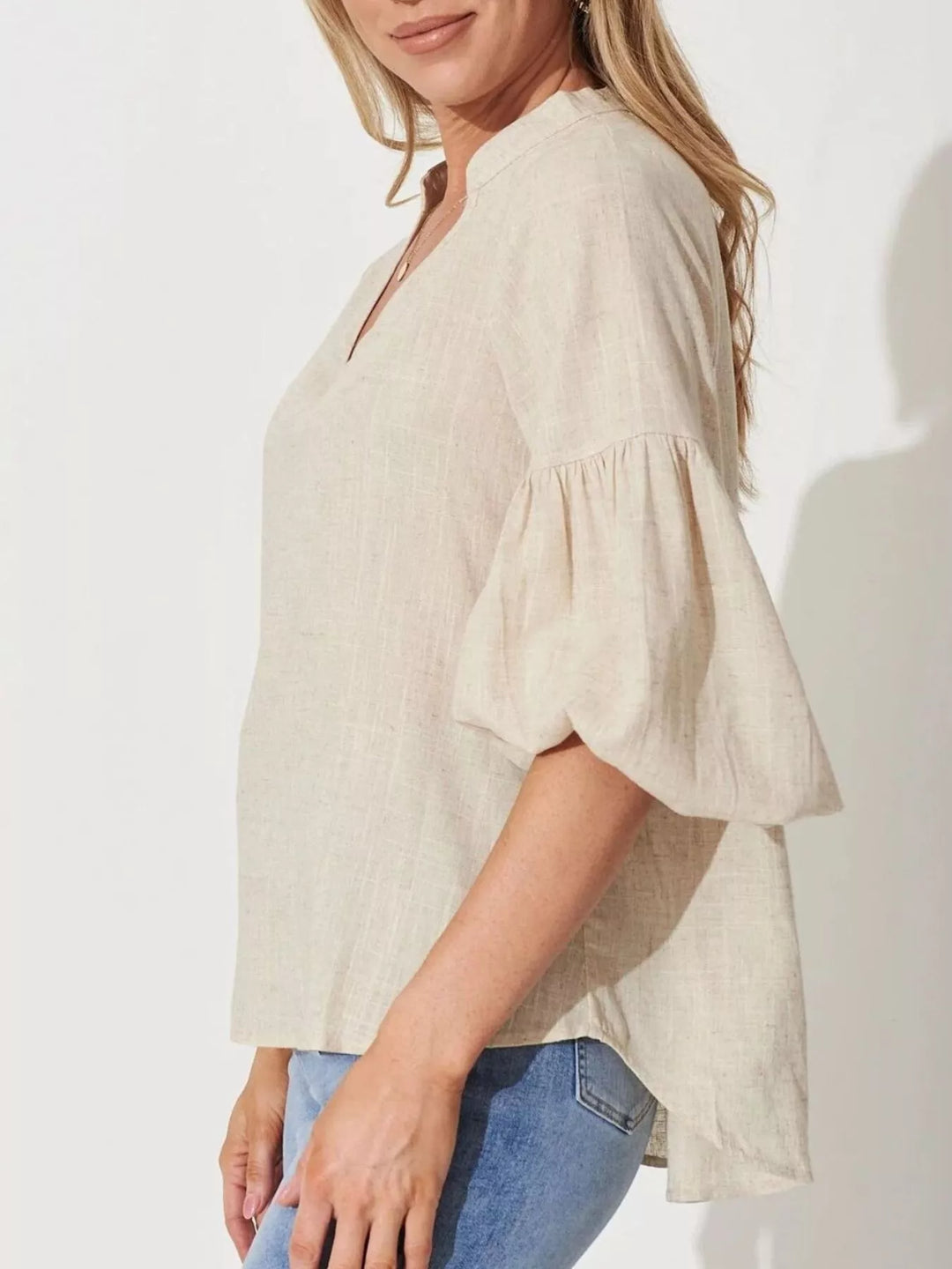 Balloon sleeve blouse with notched neckline and high-low hem