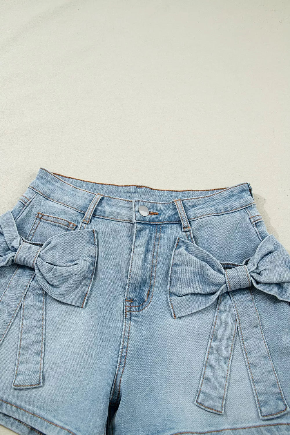Mid-rise denim shorts with bow-tied front patch pockets
