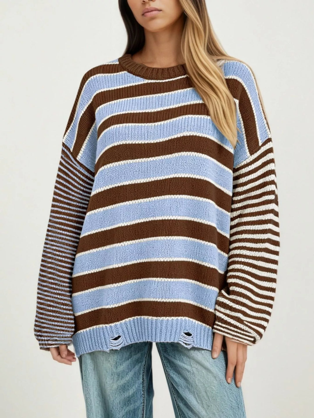 Distressed striped oversized knit sweater with raw hem