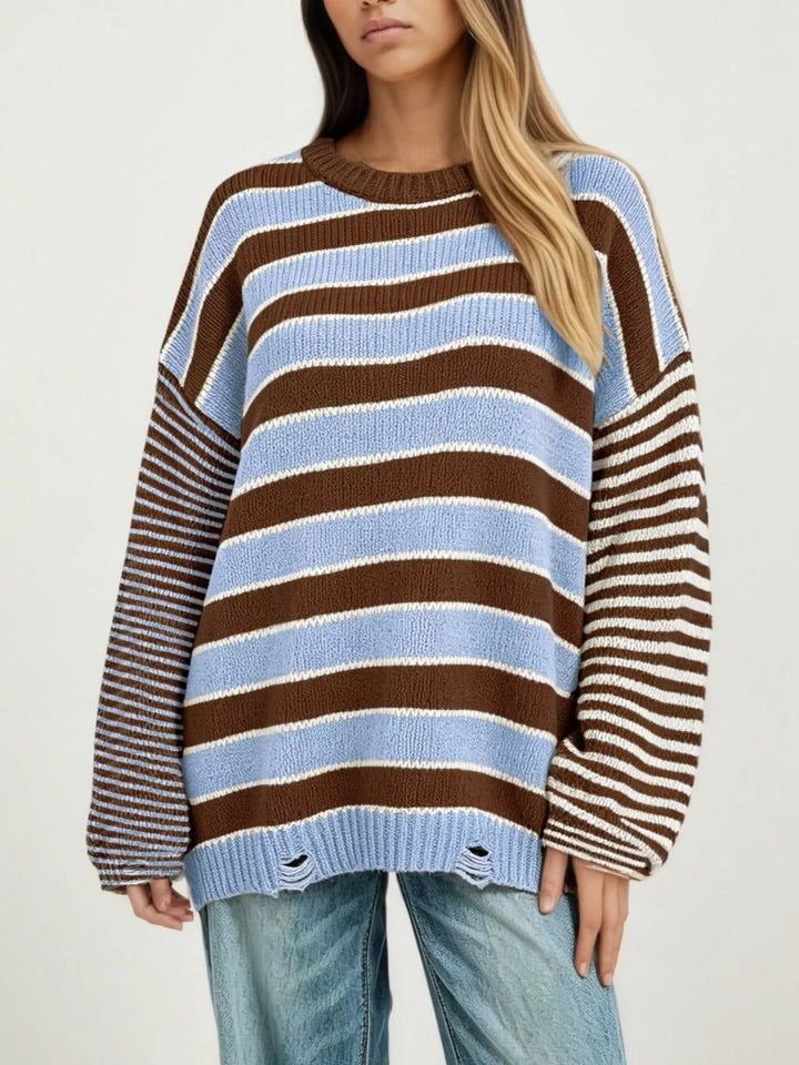 Distressed striped oversized knit sweater with raw hem