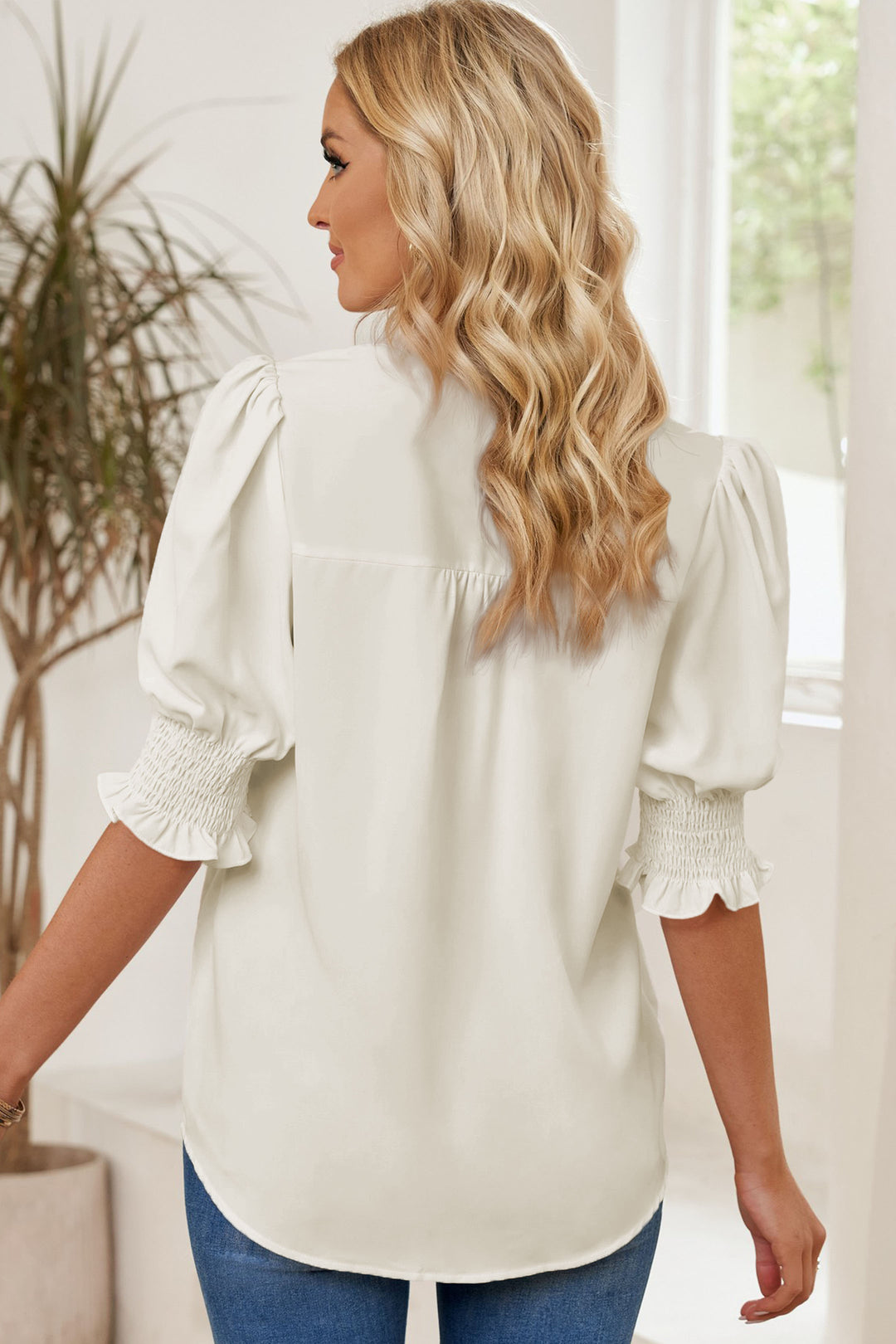 Notched neck blouse with smocked flounce sleeves