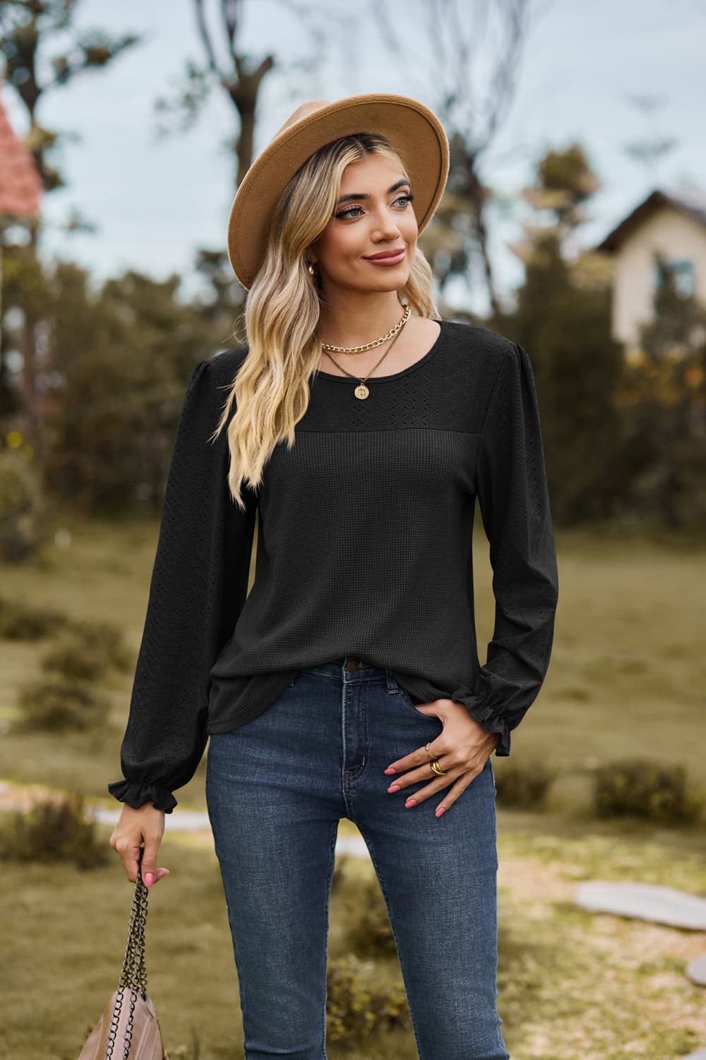 Eyelet knit puff sleeve blouse with round neckline