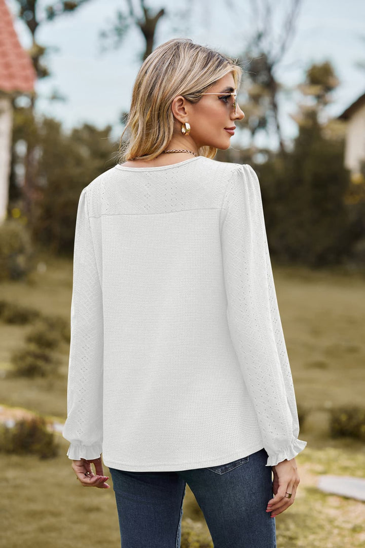 Eyelet knit puff sleeve blouse with round neckline