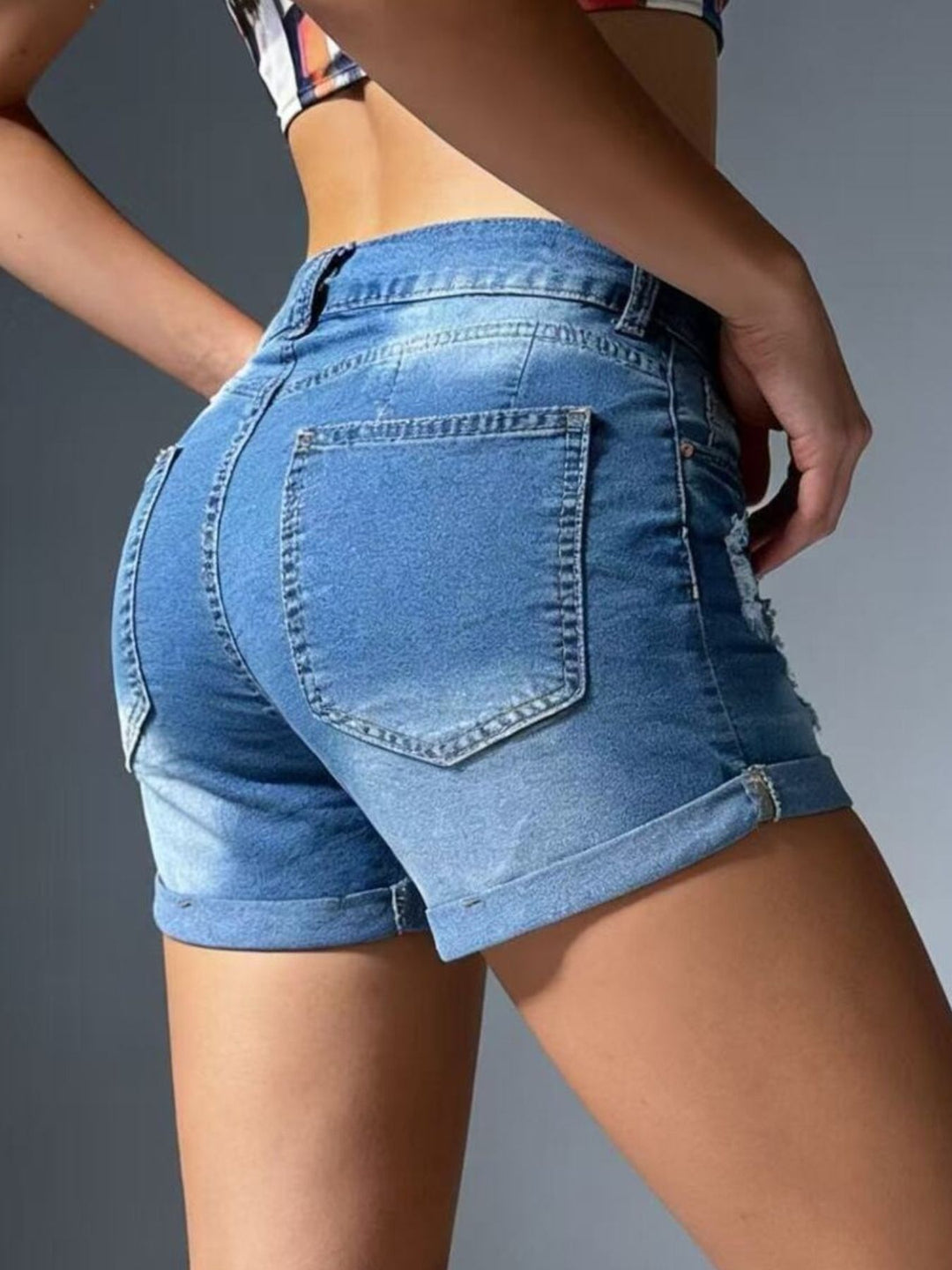 Distressed mid-rise denim shorts with cuffed hem