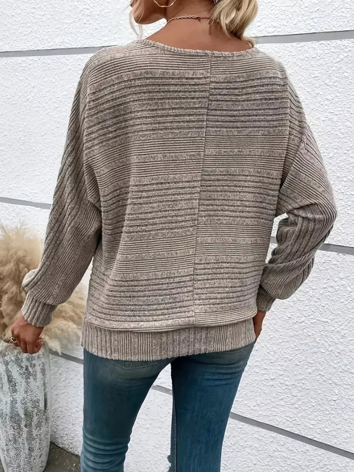 Ribbed knit quarter-zip batwing sweater with O-ring pull