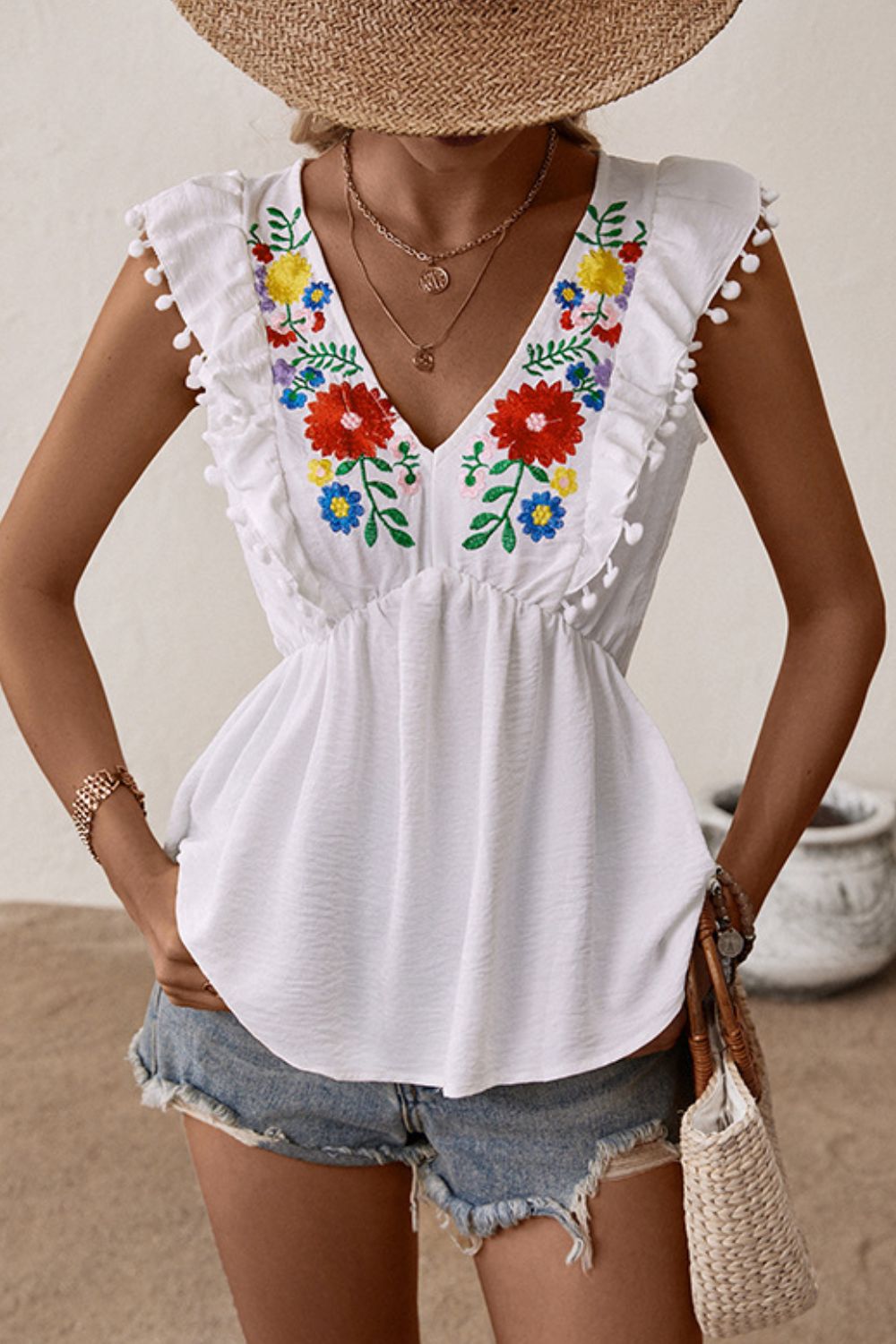 Embroidered floral babydoll top with pom-pom trim