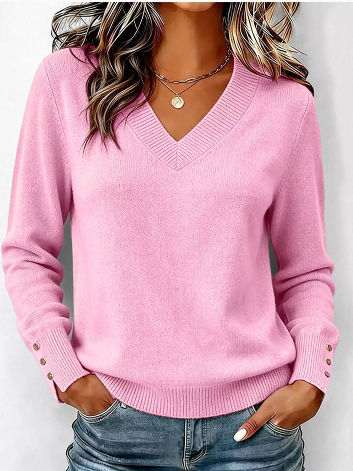 Pink V-neck long sleeve sweater with button cuffs and side slits