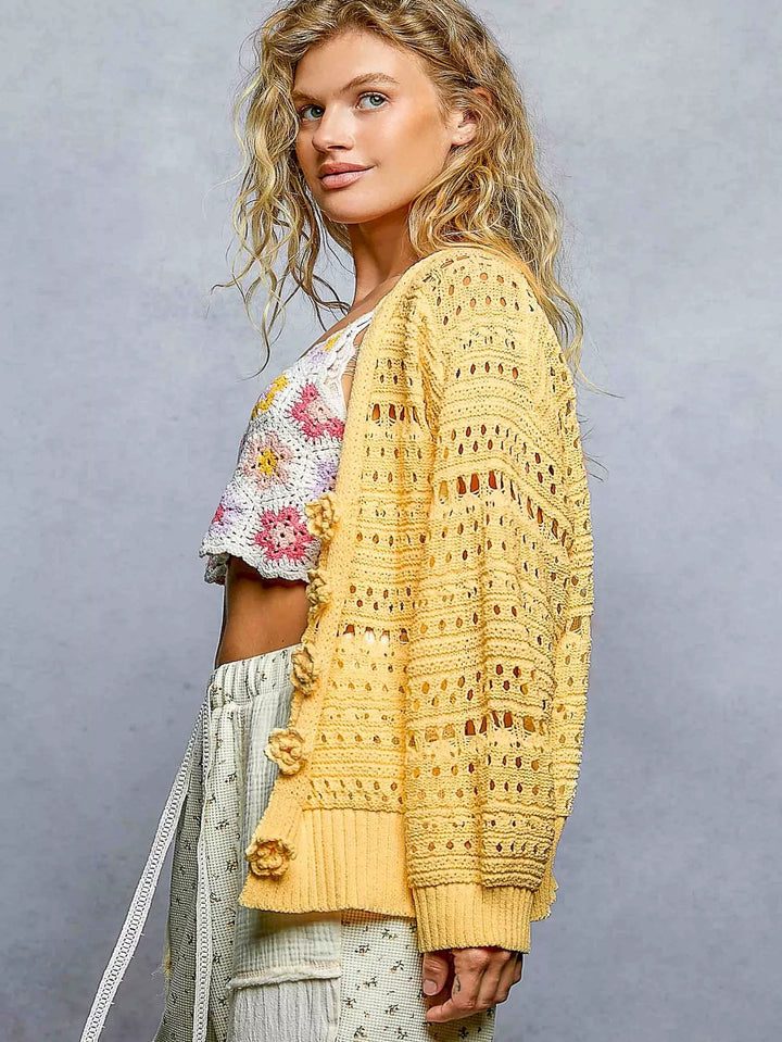 Open-knit V-neck cardigan with 3D floral button closure