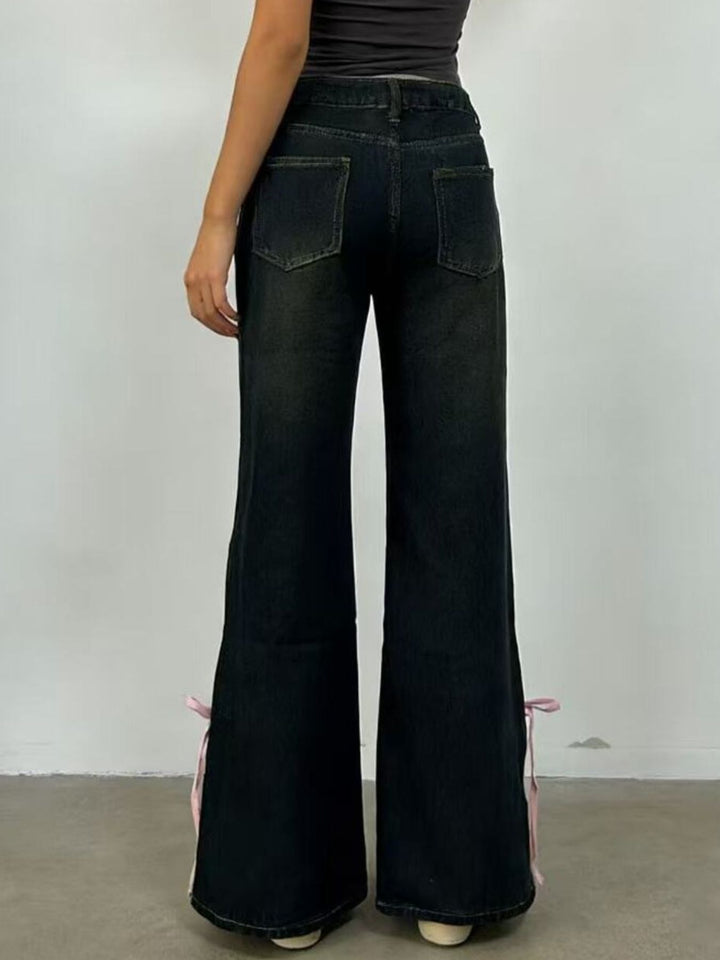 Low-rise flare jeans with ribbon bow leg slits