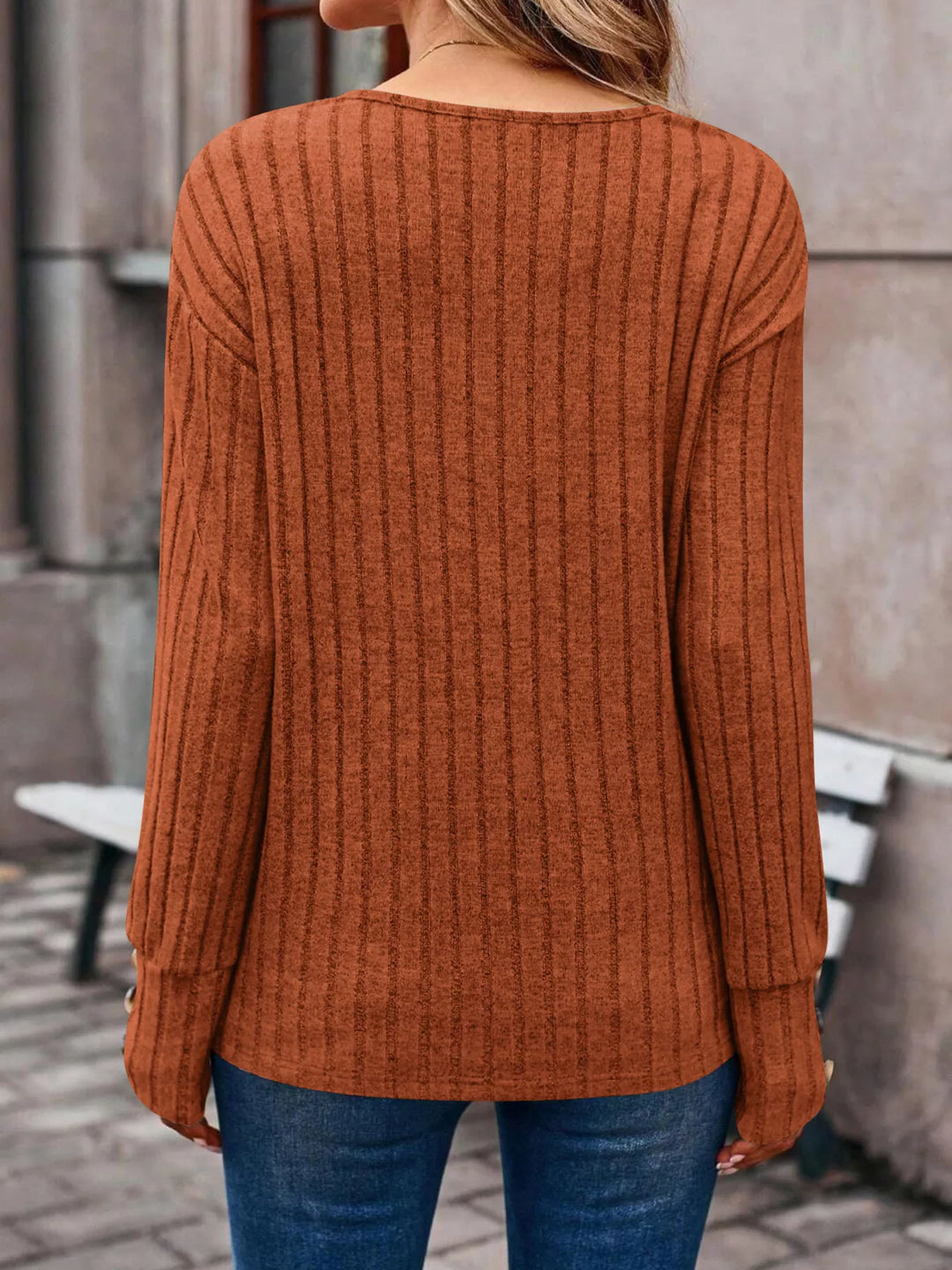 Ribbed knit V-neck top with buttoned cuffs