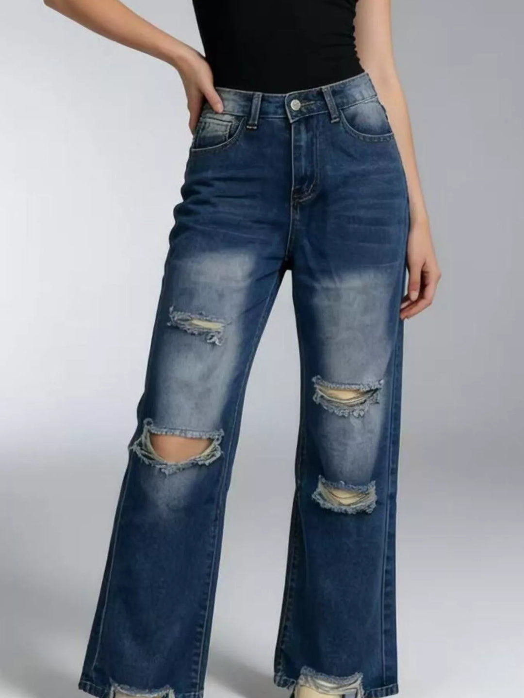 Distressed wide-leg jeans with raw frayed hem