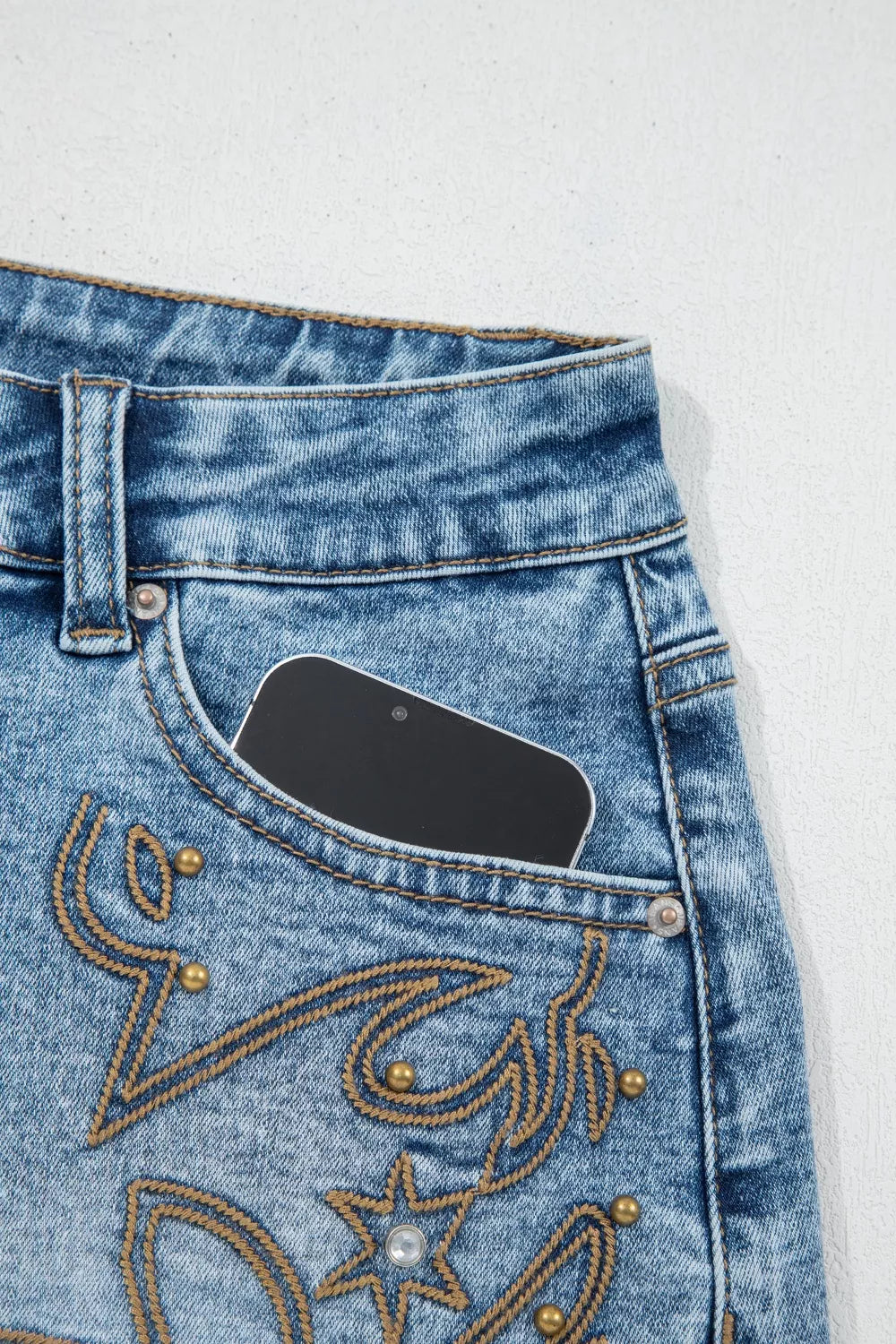 Western embroidered studded denim shorts with raw hem