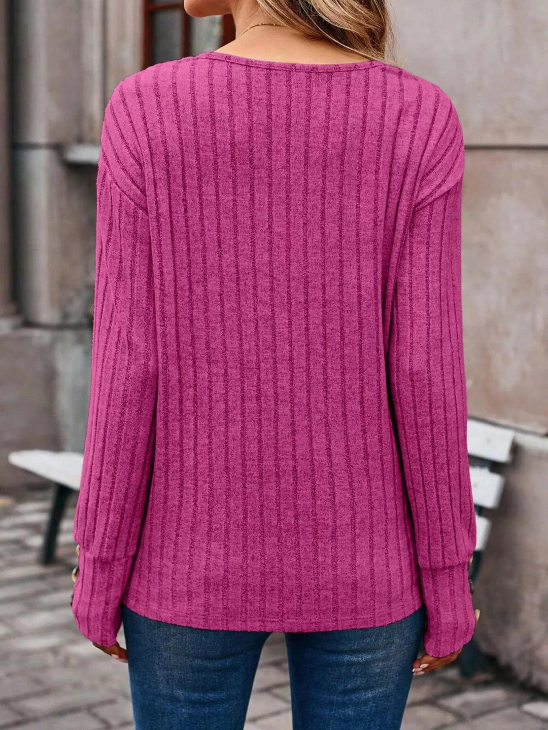 Ribbed knit V-neck top with buttoned cuffs