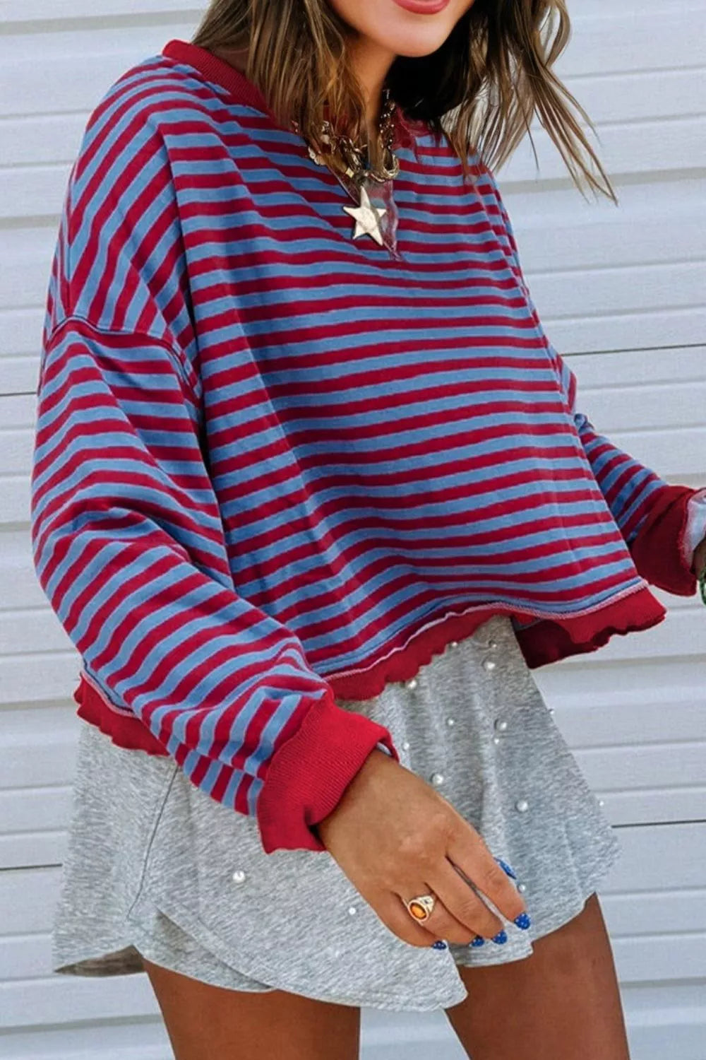 Striped exposed-seam oversized sweatshirt with contrast trim