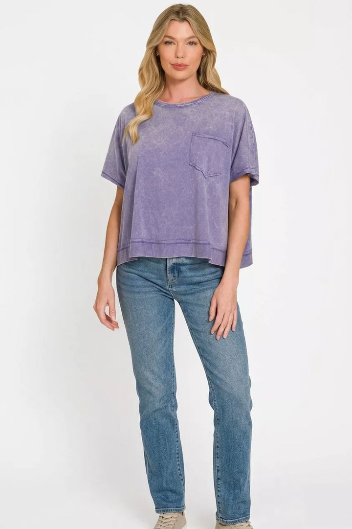 Acid-washed oversized cotton tee with chest pocket and raw hem
