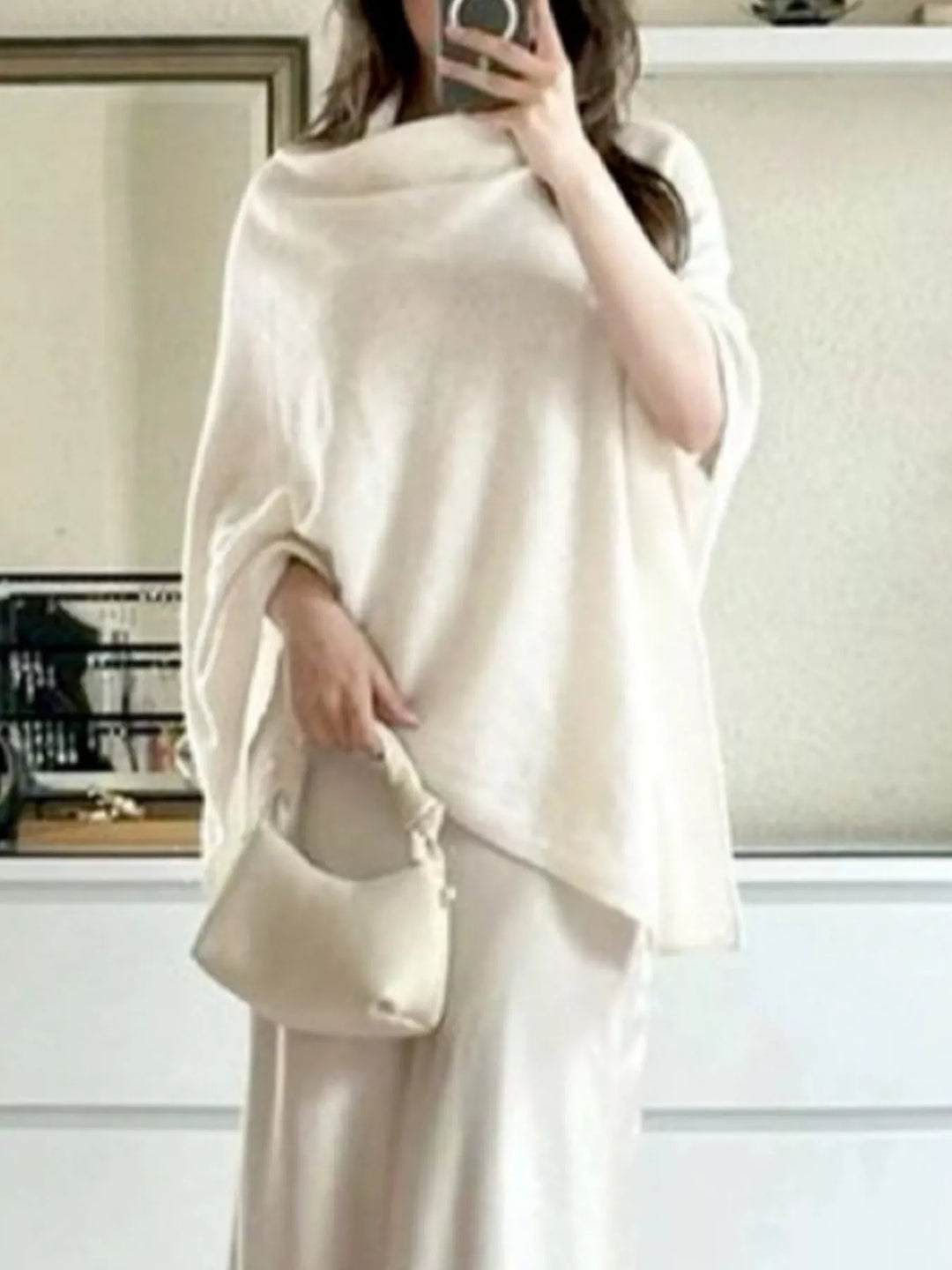 Turtleneck poncho sweater with asymmetric hem and batwing sleeves