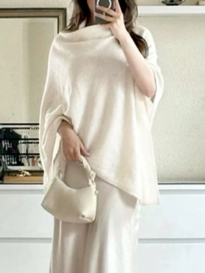 Turtleneck poncho sweater with asymmetric hem and batwing sleeves