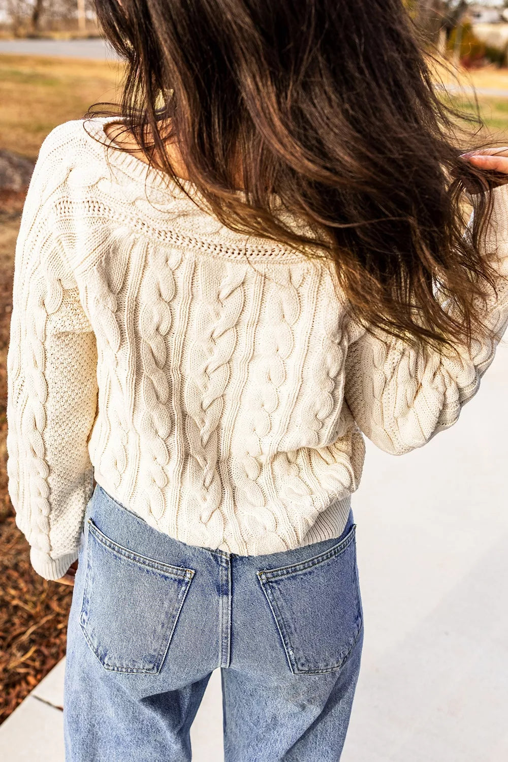 Cable knit drop shoulder sweater with ribbed cuffs
