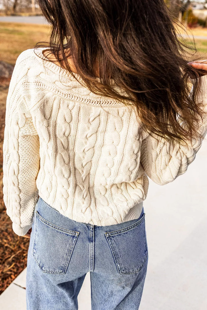 Cable knit drop shoulder sweater with ribbed cuffs