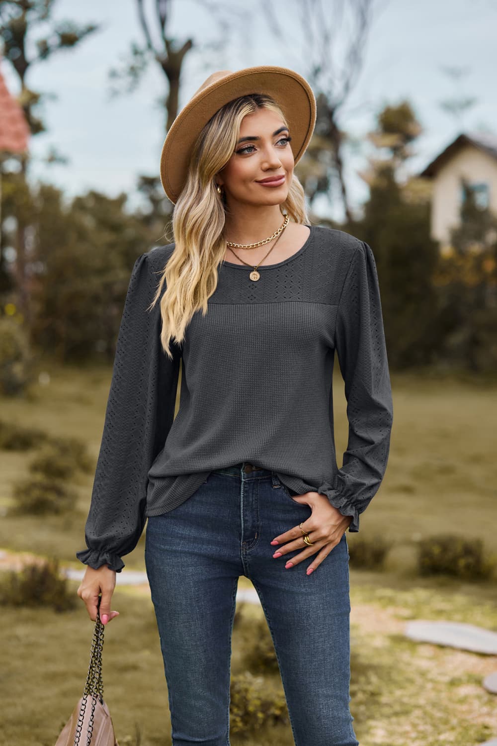 Eyelet knit puff sleeve blouse with round neckline
