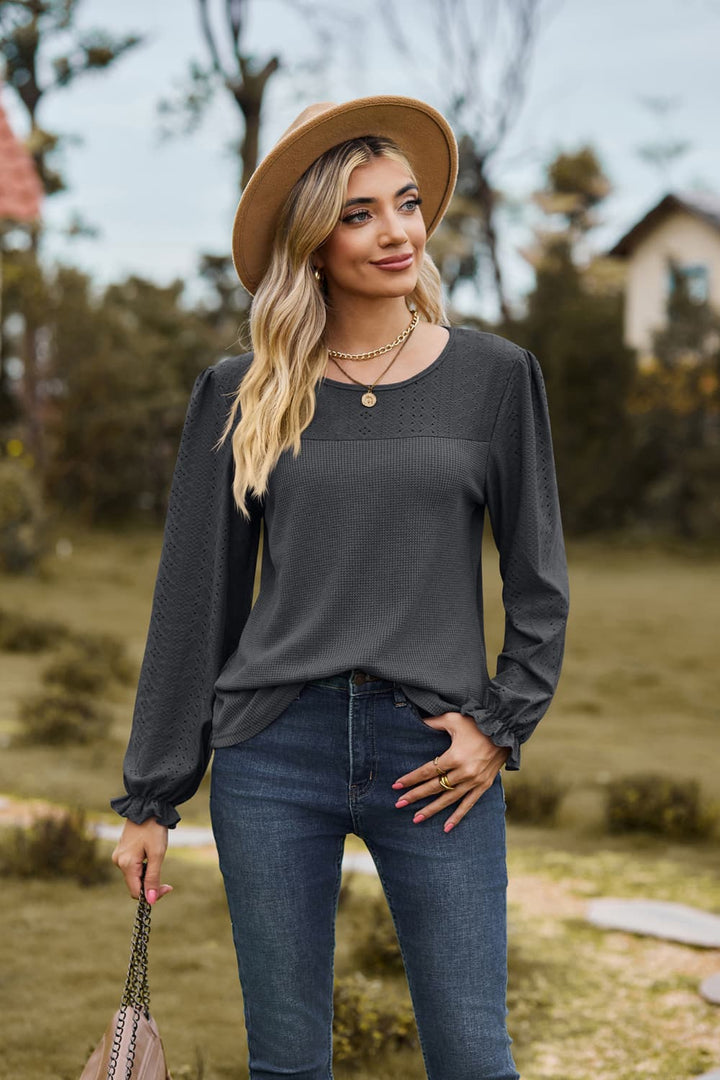 Eyelet knit puff sleeve blouse with round neckline