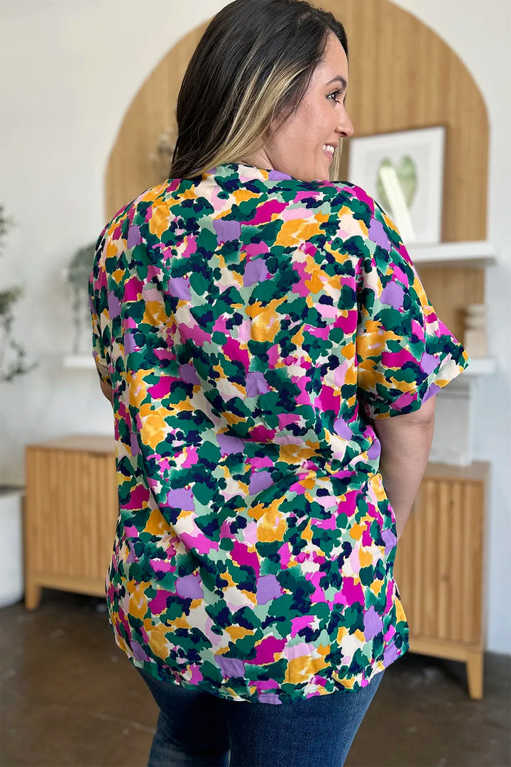 Abstract print v-neck tunic top with flutter sleeves and side slits