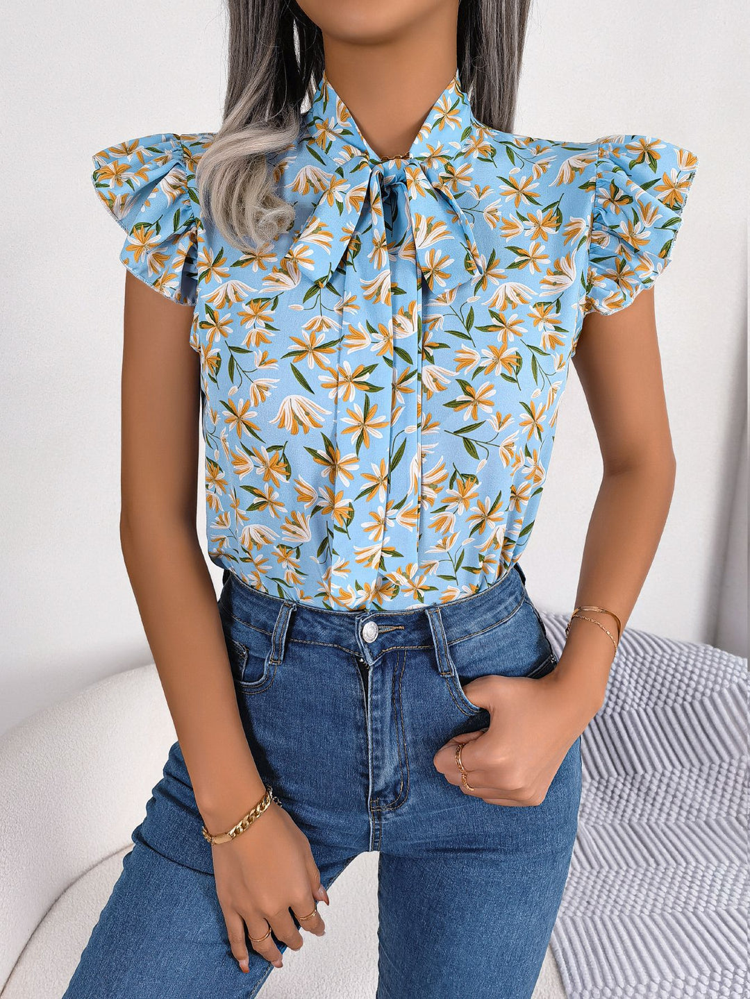 Floral tie-neck blouse with ruffled flutter sleeves
