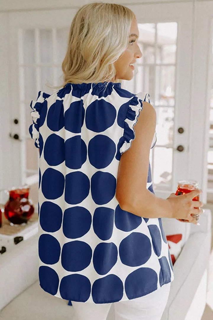 Polka dot sleeveless top with ruffle neck and shoulders