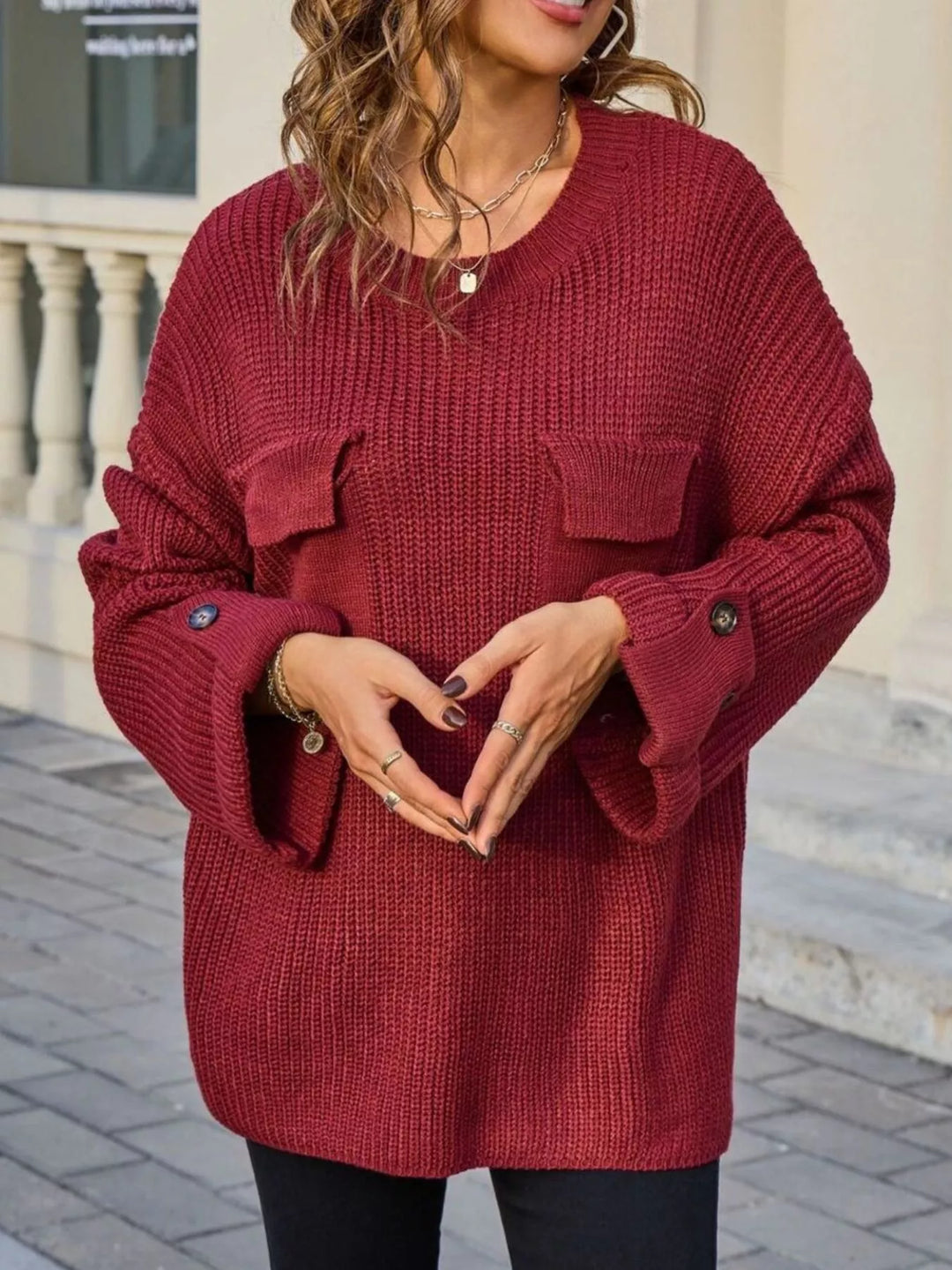 Ribbed knit sweater with chest pockets and button cuffs