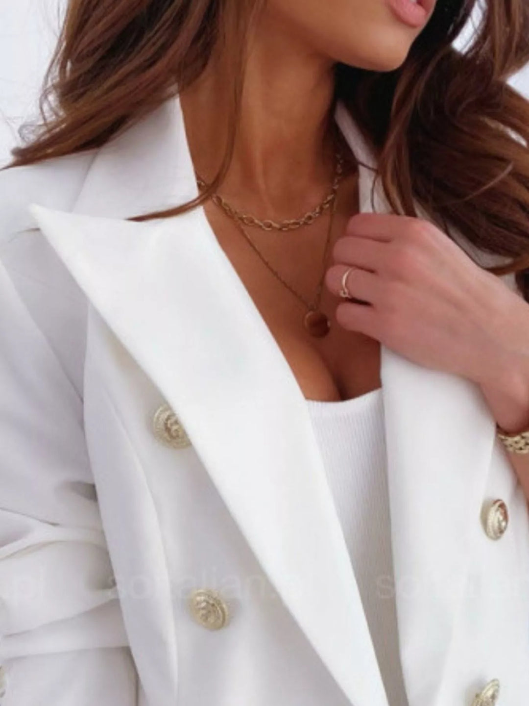 Double-breasted blazer with gold buttons and peak lapels