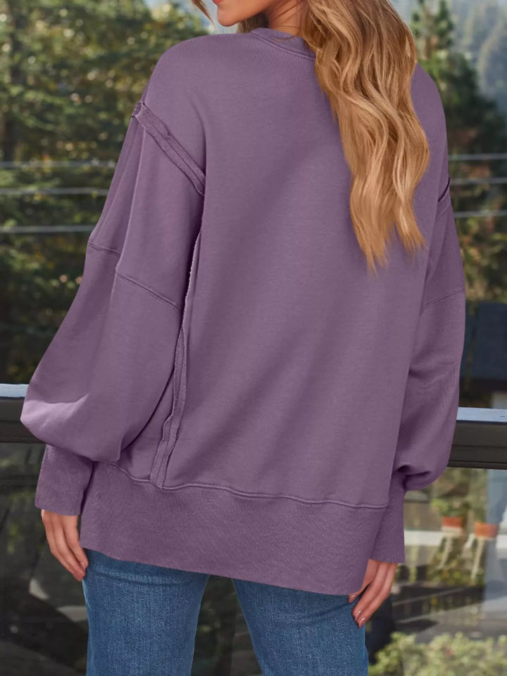 Oversized side-slit sweatshirt with exposed seams