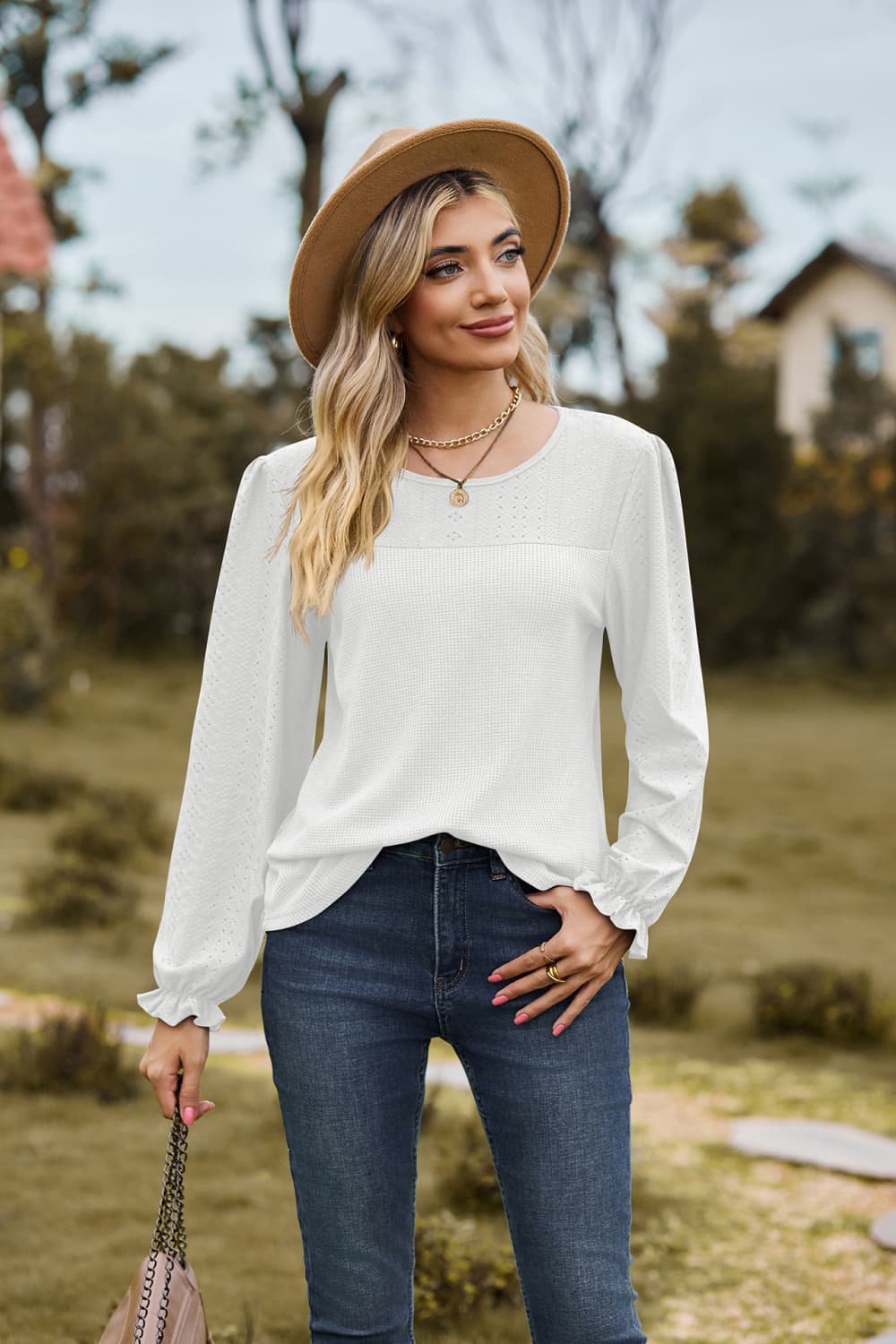 Eyelet knit puff sleeve blouse with round neckline