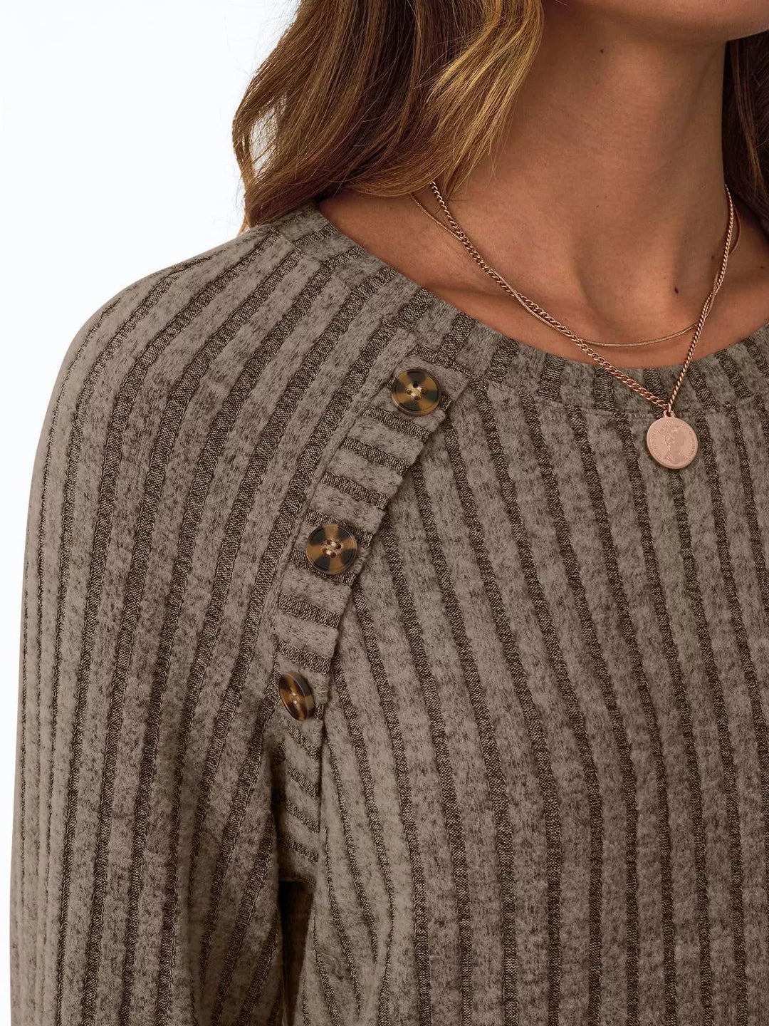 Ribbed knit long sleeve top with decorative shoulder buttons