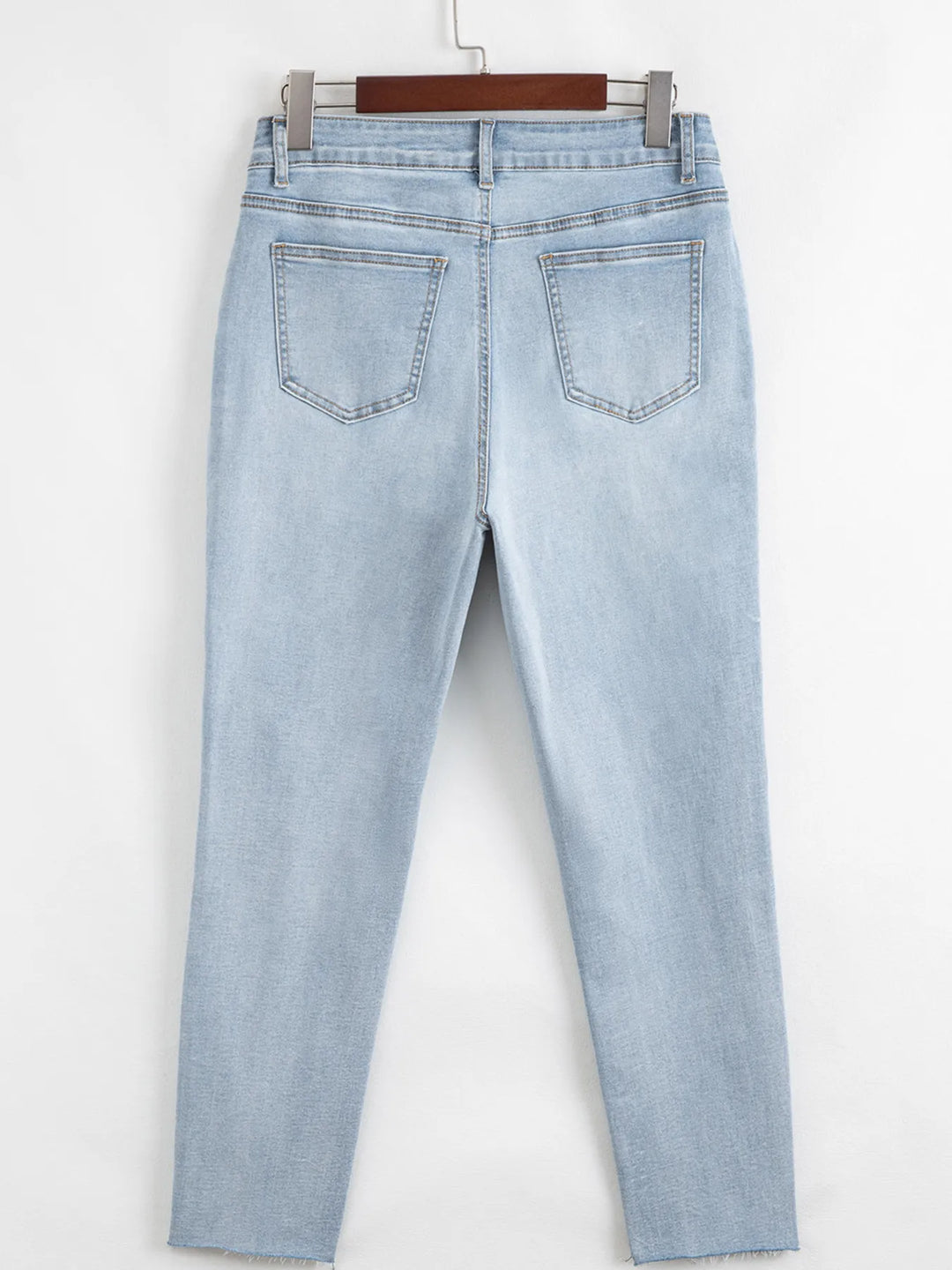 Distressed mid-rise ankle skinny jeans with raw hem