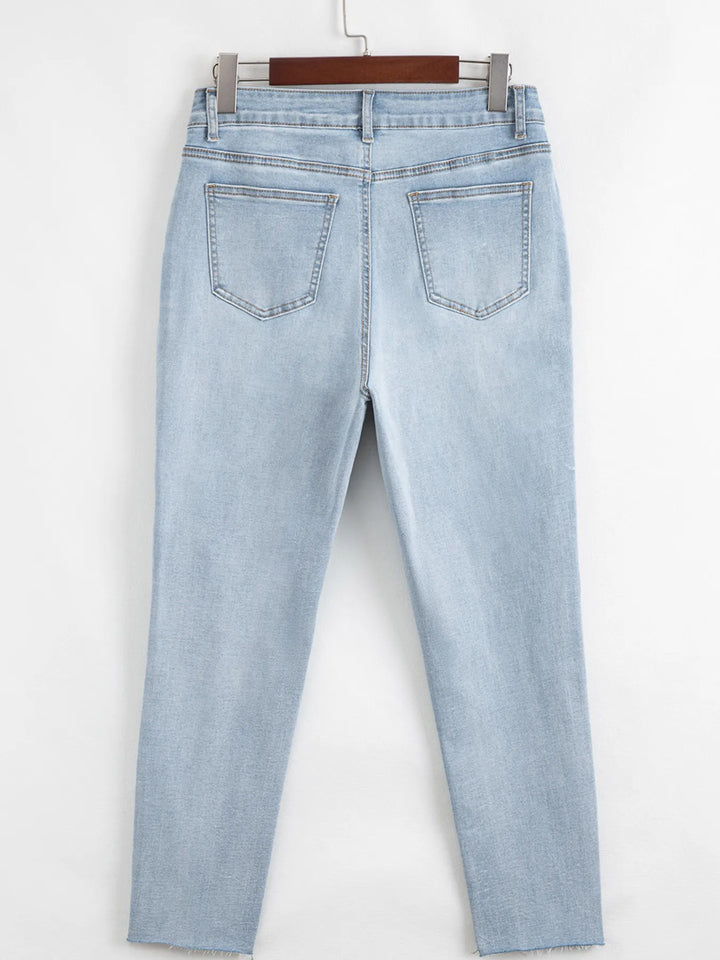 Distressed mid-rise ankle skinny jeans with raw hem