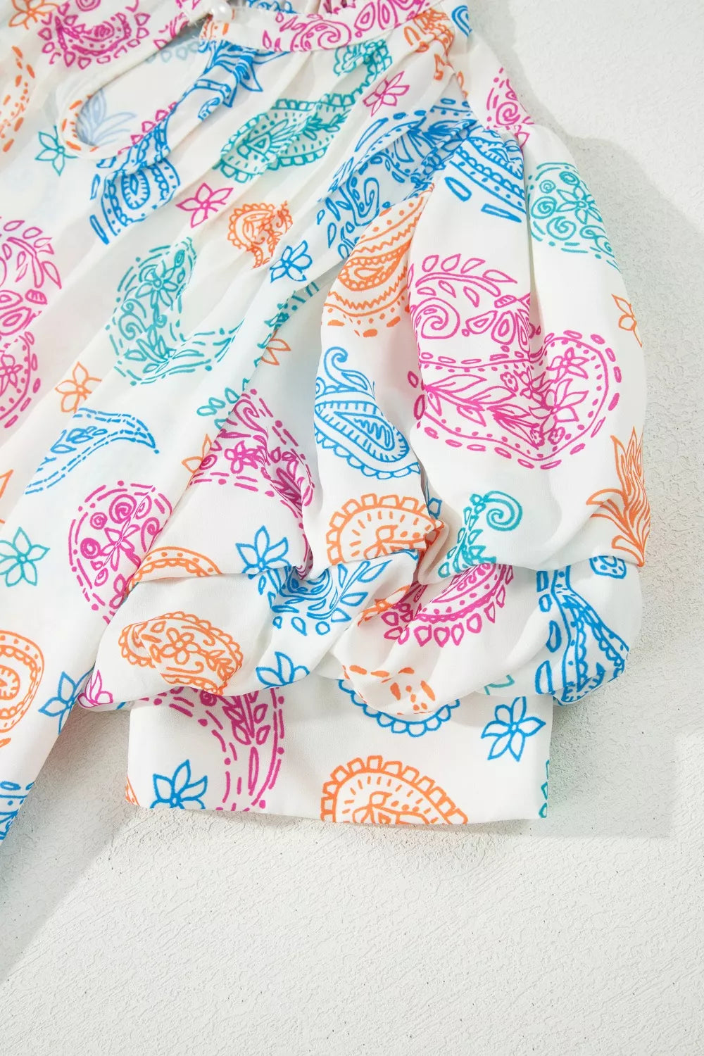 Paisley print keyhole blouse with ruffle neck and puff sleeves