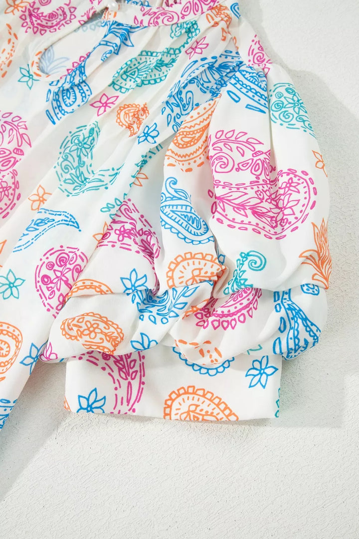 Paisley print keyhole blouse with ruffle neck and puff sleeves