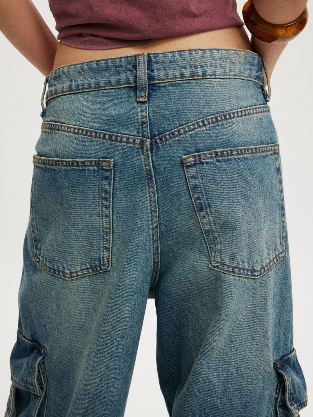 Vintage wash wide-leg cargo jeans with strap pockets