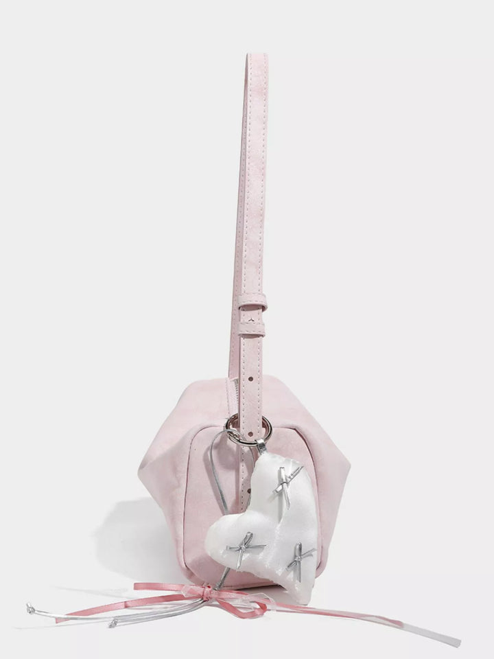 Adjustable strap crossbody bag with heart charm and bow trim