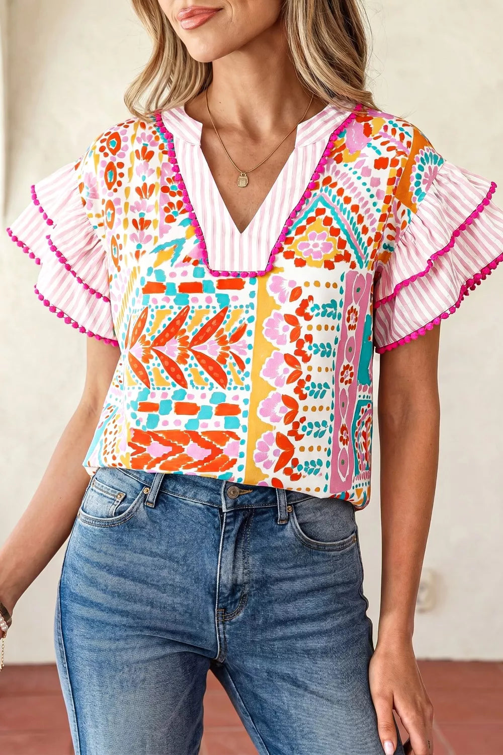Floral Patchwork mixed print blouse with ruffle sleeves and pom-pom trim